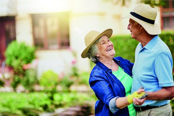 elderly couple dancing outside garden wear