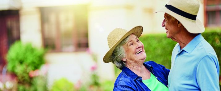 elderly couple dancing outside garden wear