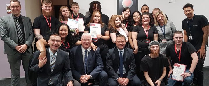 group of people in office holding certificates