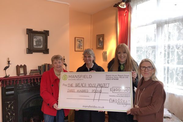 The breach house project four women holding cheque