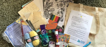 stationery, bags, activities, yarn, cards, and chocolate on floor