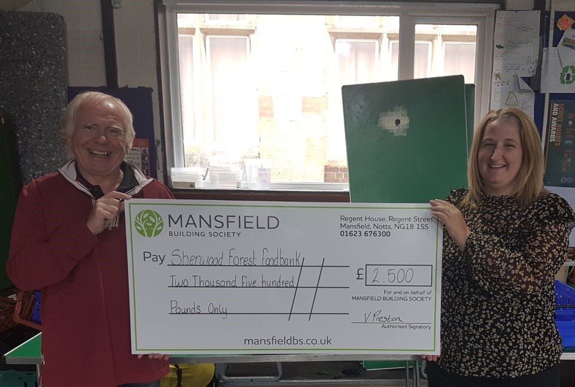 sherwood forest food bank man and woman holding mansfield cheque