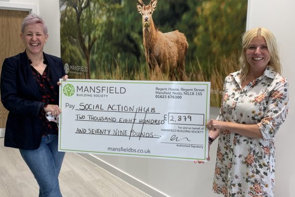 two women holding mansfield cheque deer painting background