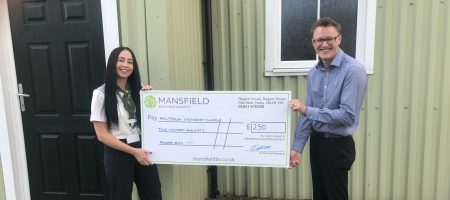 Hillstown methodist church man and woman holding mansfield cheque
