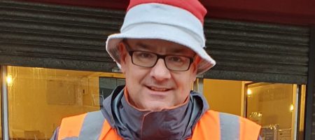 Man orange hi viz top christmas bucket hat star trophy