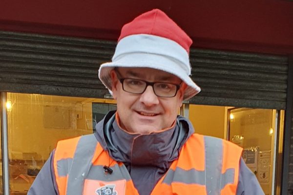 Man orange hi viz top christmas bucket hat star trophy