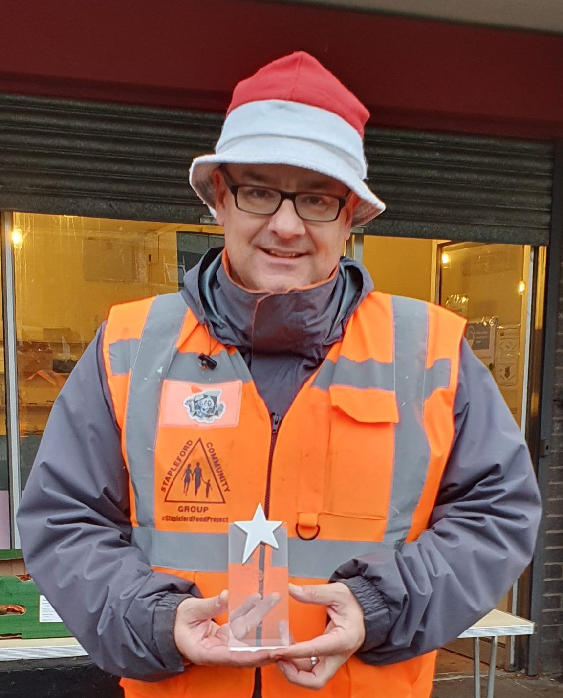 Man orange hi viz top christmas bucket hat star trophy