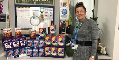 Woman standing next to easter eggs