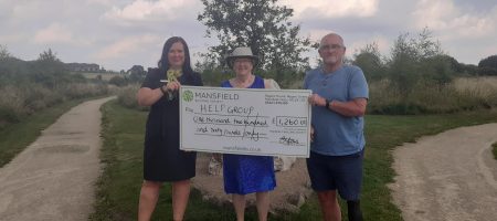 Man and two women HELP group large mansfield bs cheque