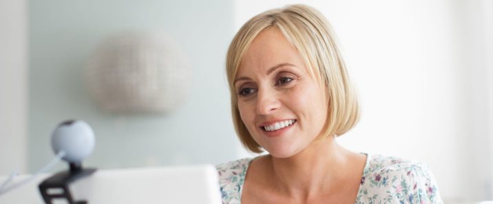 Woman on video call on laptop smiling