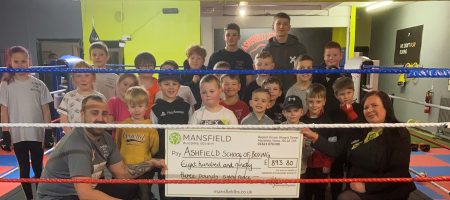 Children in boxing ring holding large cheque mansfield bs