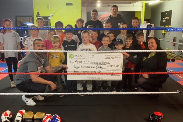 Children in boxing ring holding large cheque mansfield bs