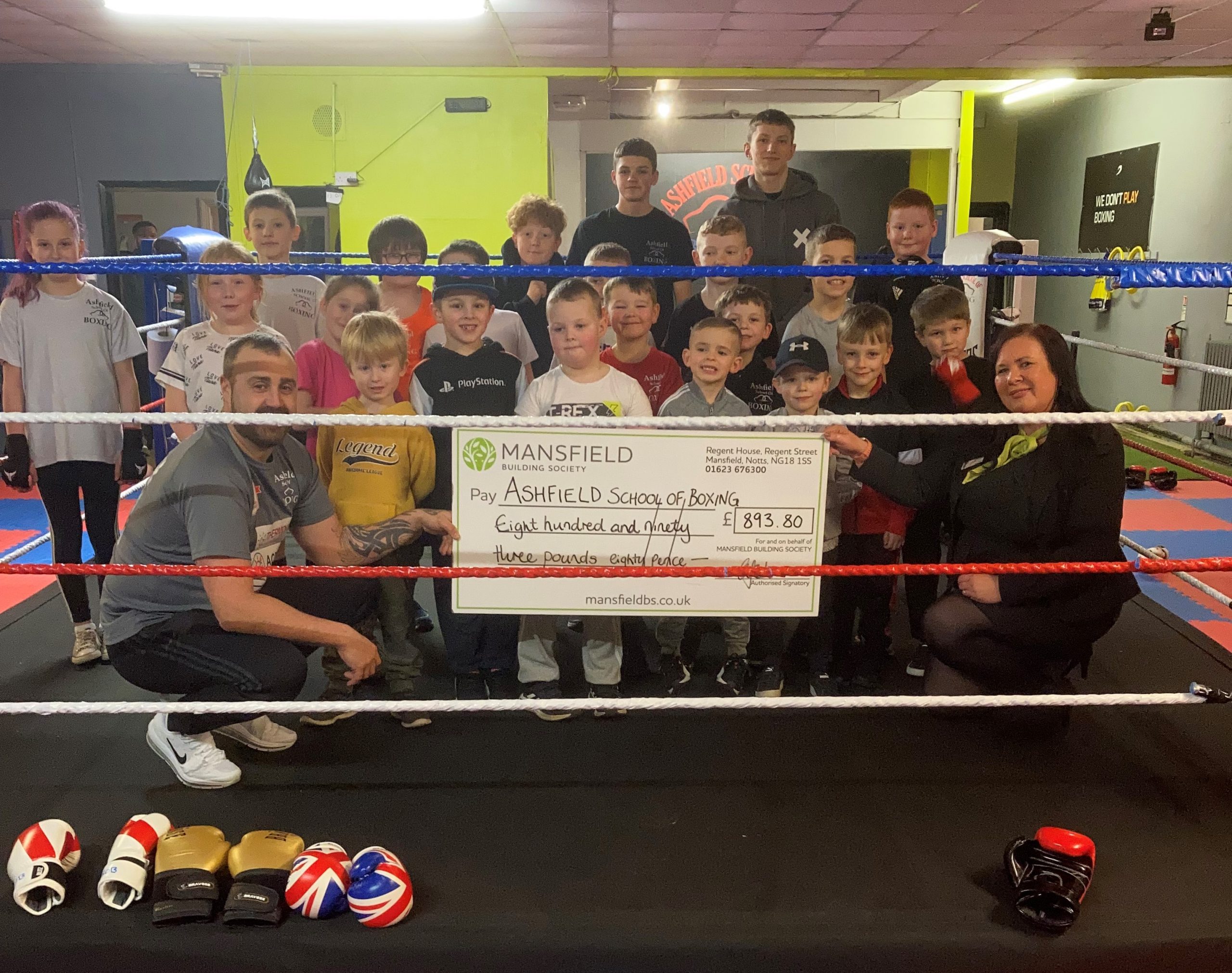 Children in boxing ring holding large cheque mansfield bs