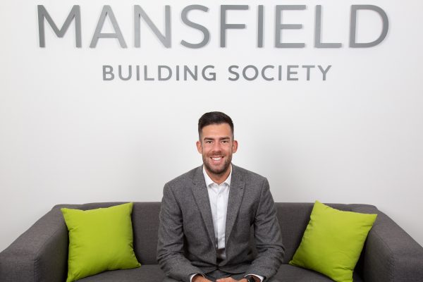 Mansfield Building Society Tom Denman Molloy sitting on sofa