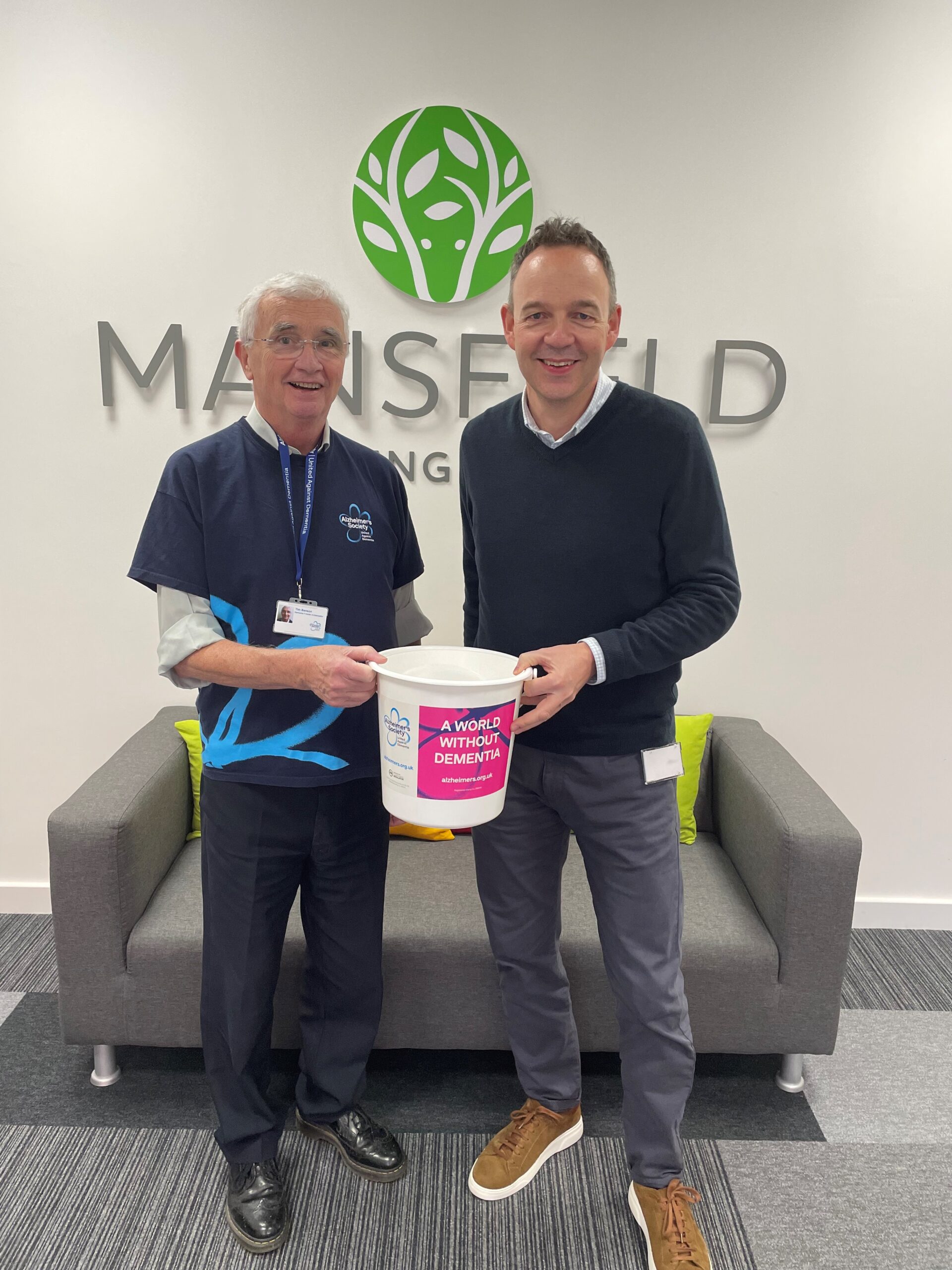 Two men holding bucket - mansfield bs and alzheimers society