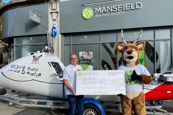 Stanley Stag cheque presentation with rowing boat outside a Mansfield Building Society branch