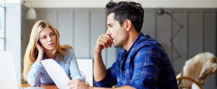 Young couple paying bills online